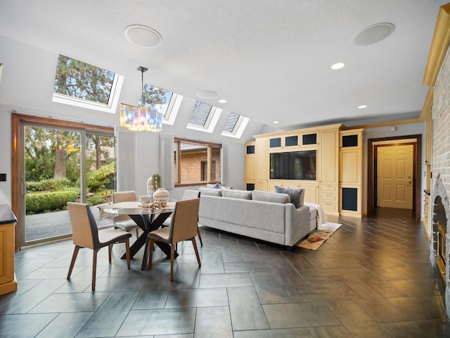 dining room featuring lofted ceiling with skylight