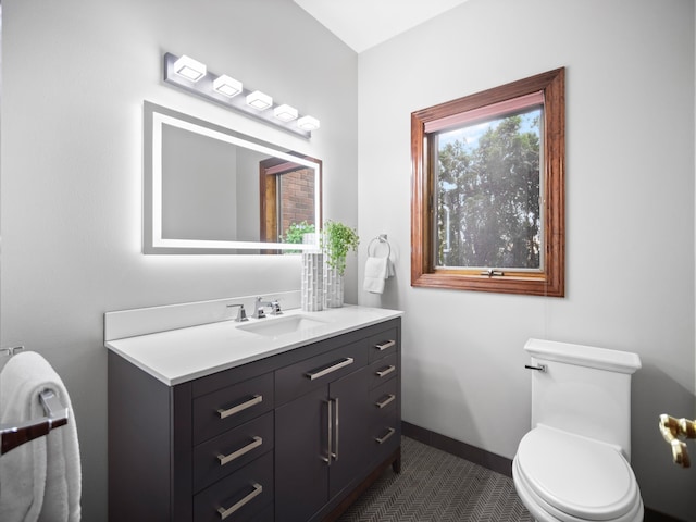 bathroom featuring tile patterned flooring, vanity, and toilet