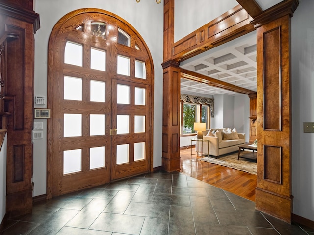 foyer with beam ceiling, french doors, and coffered ceiling