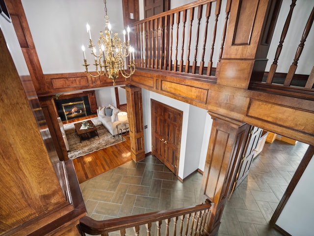 stairs featuring a notable chandelier