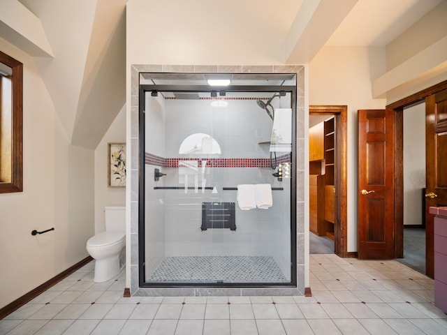 bathroom with tile patterned flooring, toilet, and walk in shower