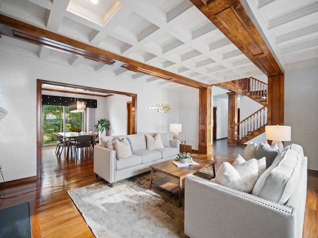 living room featuring beamed ceiling, wood-type flooring, ornate columns, and coffered ceiling