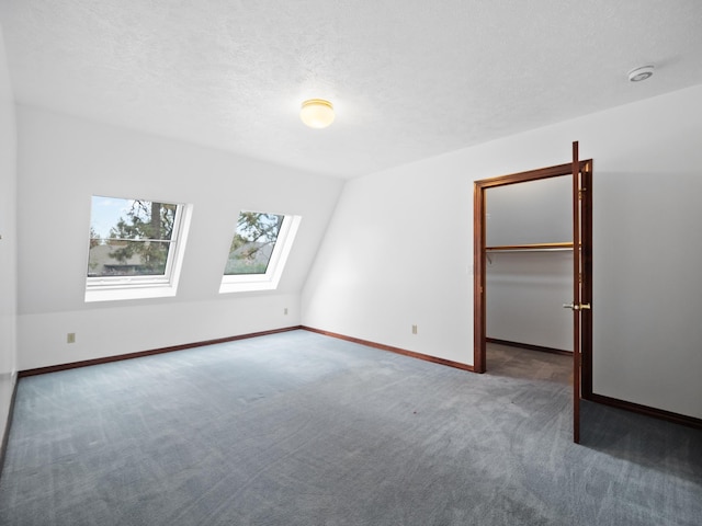 carpeted spare room featuring a skylight