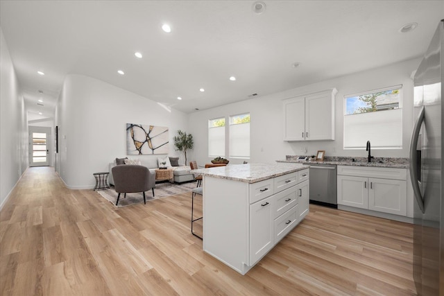 kitchen with white cabinetry, sink, a kitchen island, and stainless steel appliances