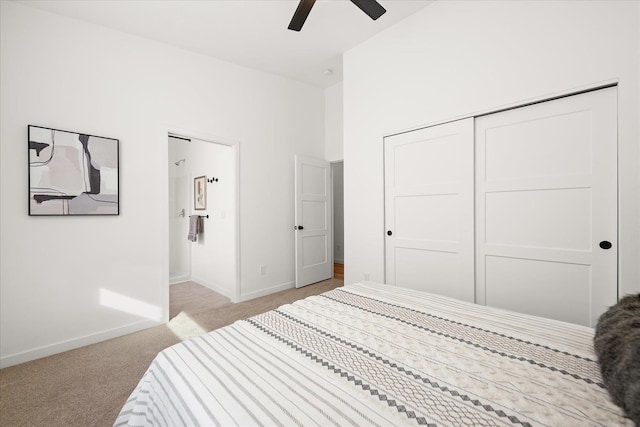 bedroom with ceiling fan, a closet, and light colored carpet