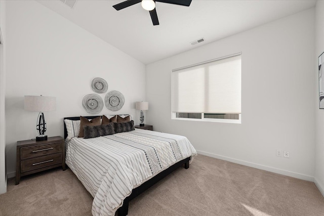 bedroom featuring ceiling fan, light carpet, and vaulted ceiling