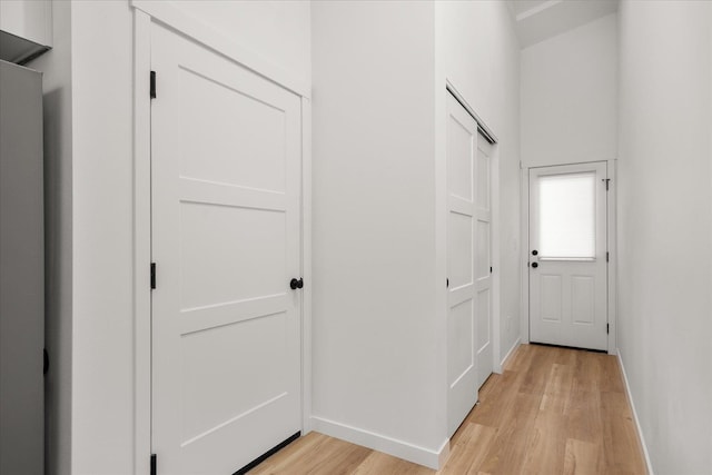 corridor featuring light hardwood / wood-style floors