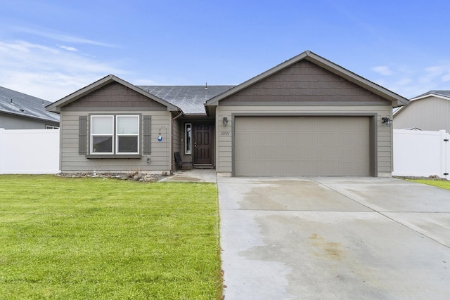 ranch-style home featuring a front yard and a garage