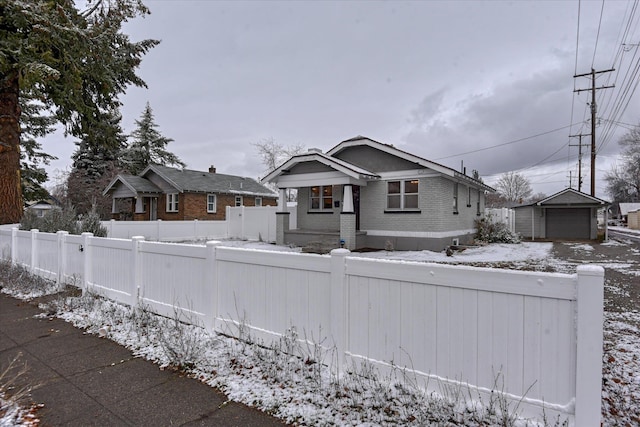 view of front of property featuring a garage and an outbuilding