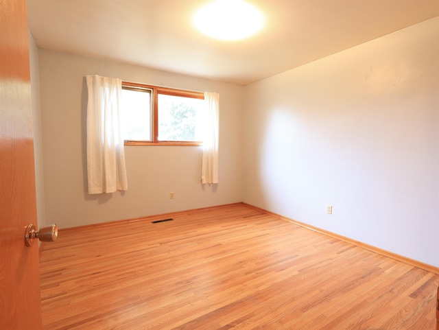 spare room featuring light wood-type flooring