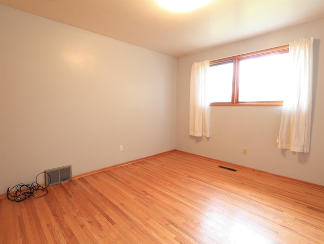 unfurnished room featuring light hardwood / wood-style flooring