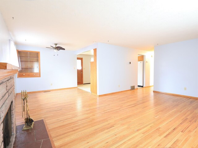 unfurnished living room featuring light hardwood / wood-style floors and ceiling fan