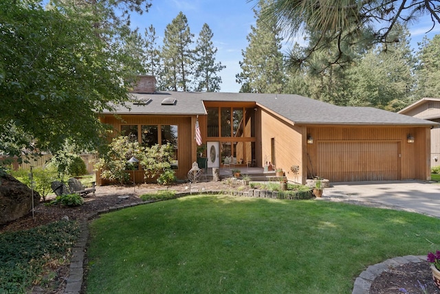 view of front of property with a front lawn and a garage