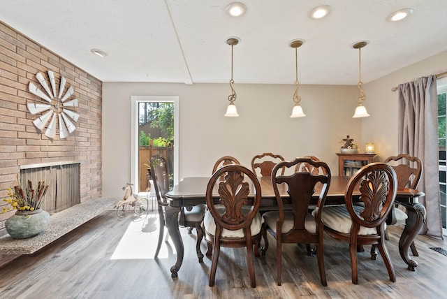 dining room featuring hardwood / wood-style floors and a fireplace