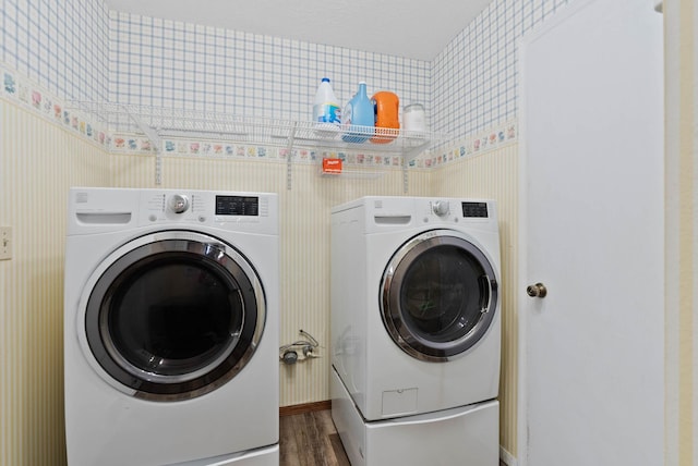 laundry room featuring dark wood-type flooring and washing machine and dryer