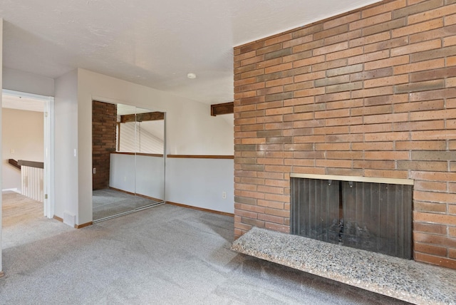 unfurnished living room featuring a fireplace and light colored carpet