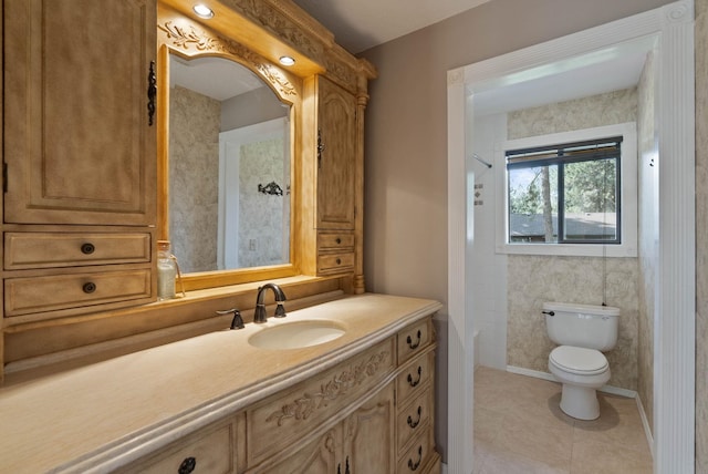 bathroom featuring tile patterned floors, vanity, and toilet