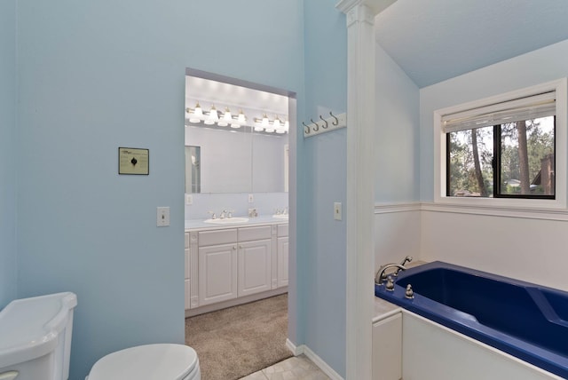 bathroom featuring a bathtub, vanity, and toilet