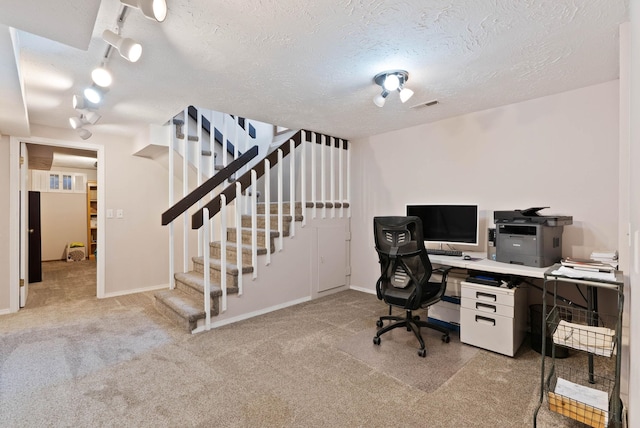 office space featuring a textured ceiling and light colored carpet