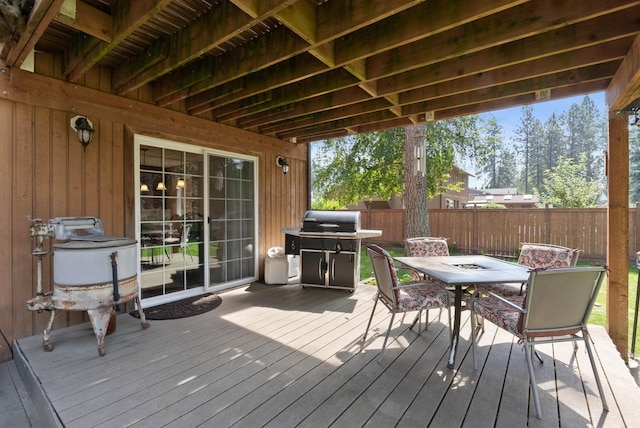 wooden terrace featuring a grill