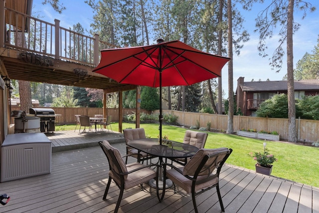 wooden deck with a yard and area for grilling