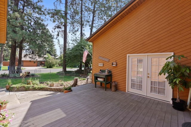 deck featuring a lawn and french doors