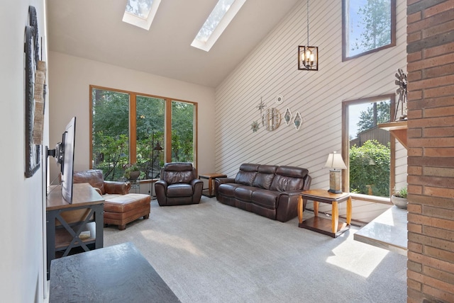 carpeted living room with a skylight and high vaulted ceiling