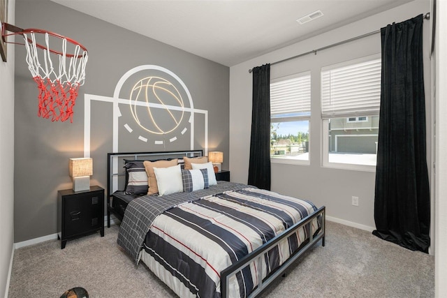 carpeted bedroom featuring multiple windows