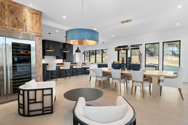 dining room featuring light wood-type flooring and wine cooler