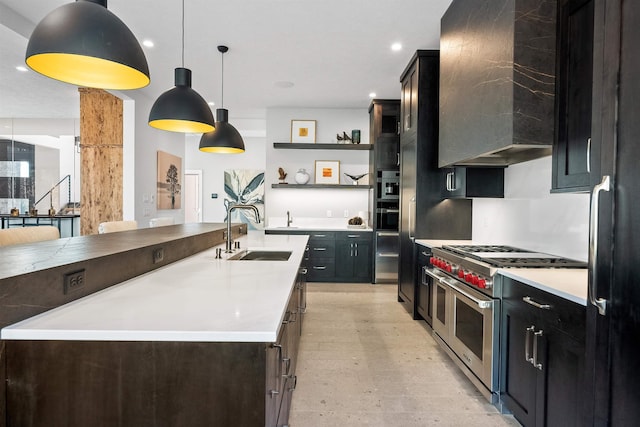 kitchen with pendant lighting, double oven range, an island with sink, custom range hood, and sink