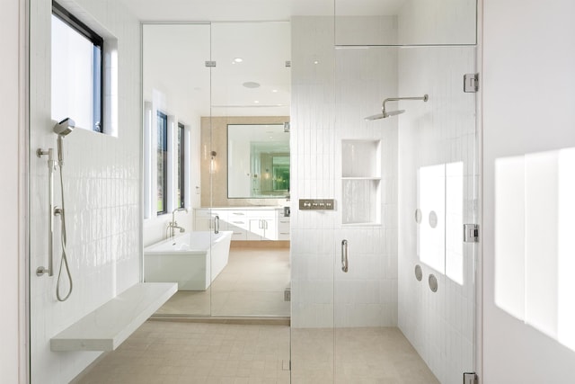 bathroom featuring tile walls, an enclosed shower, a wealth of natural light, and vanity