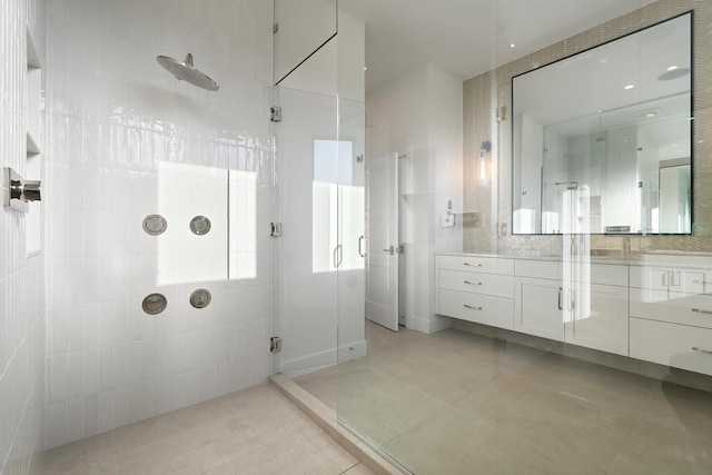 bathroom featuring tile patterned floors, vanity, and a shower with shower door