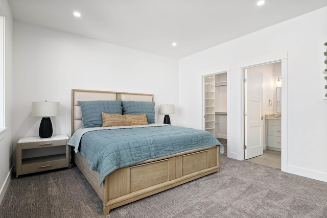 carpeted bedroom with ensuite bathroom, a closet, and a spacious closet