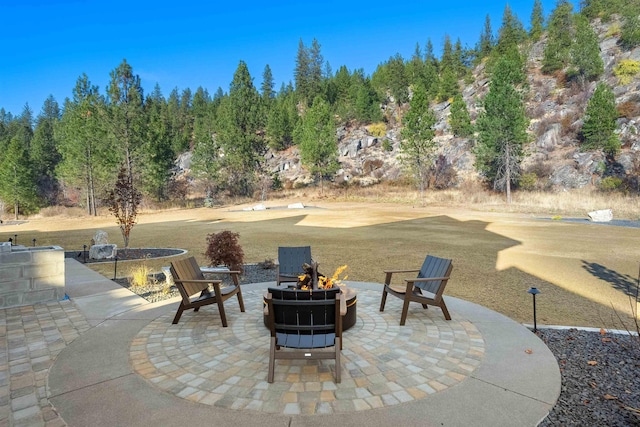 view of patio / terrace featuring an outdoor fire pit