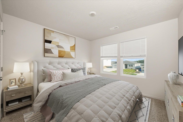 carpeted bedroom with a textured ceiling