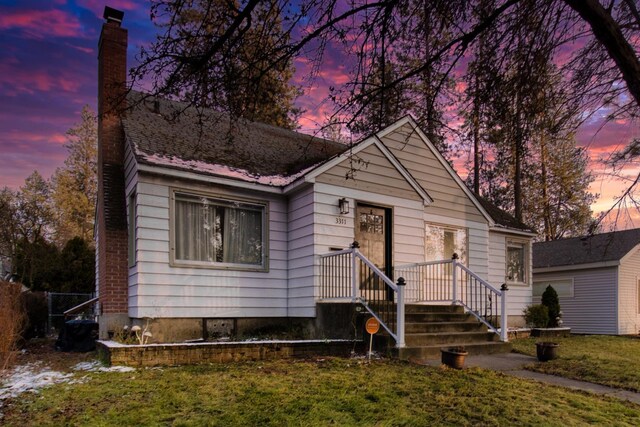 bungalow-style house with a lawn