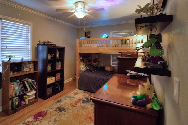 bedroom featuring crown molding, ceiling fan, and light wood-type flooring