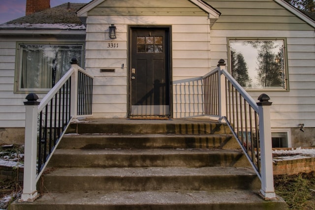 view of exterior entry at dusk