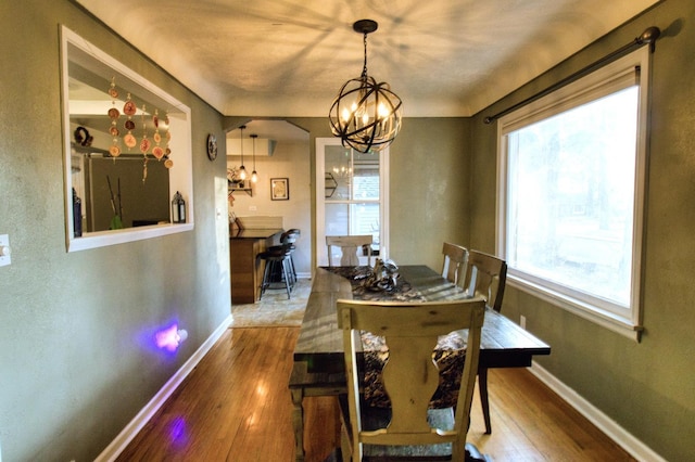 dining room featuring wood-type flooring and a notable chandelier