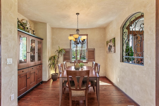 dining room featuring a notable chandelier and dark hardwood / wood-style flooring