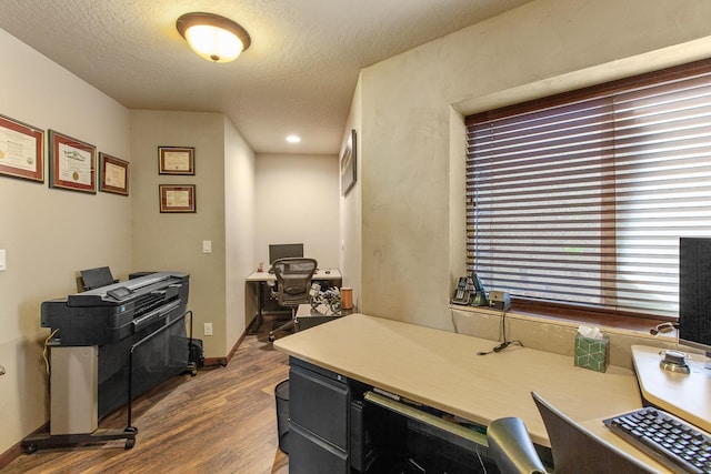 office featuring wood-type flooring and a textured ceiling