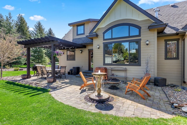 rear view of house with an outdoor fire pit, a patio area, a lawn, and a pergola