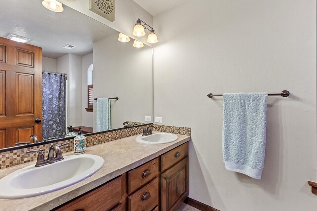 bathroom featuring backsplash and vanity