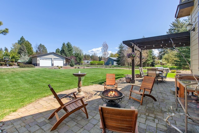 view of patio / terrace featuring an outdoor fire pit, a pergola, and a garage