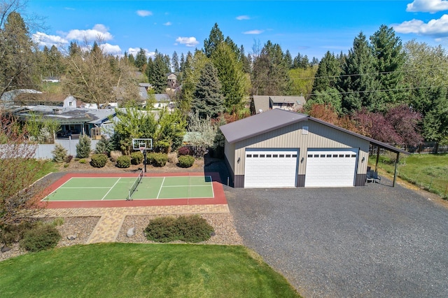 exterior space with basketball court, a front lawn, a garage, and an outdoor structure