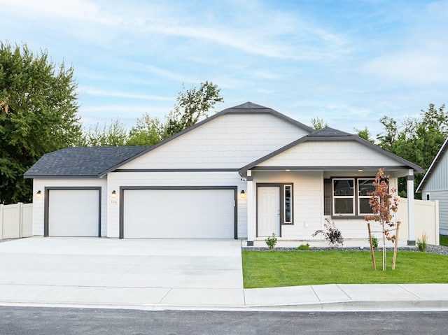 ranch-style home featuring a front yard and a garage