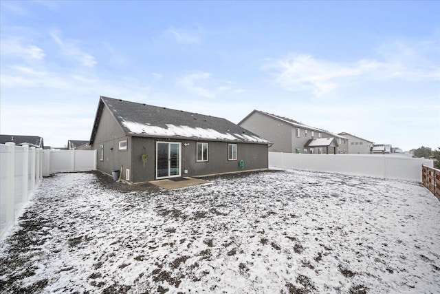 view of snow covered rear of property