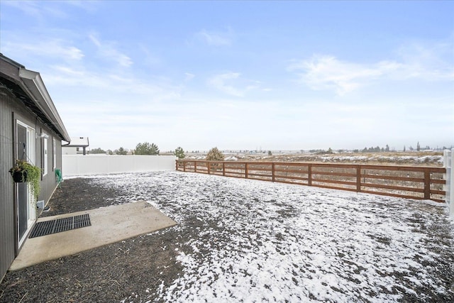 view of yard layered in snow