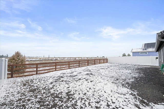 view of yard layered in snow