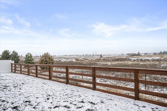 yard layered in snow featuring a rural view